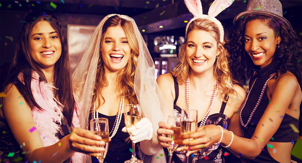 Bride celebrating with her bridal party, toasting with champagne